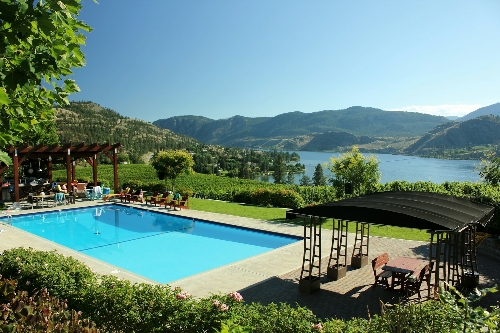 Outdoor pool with a lake and mountain view