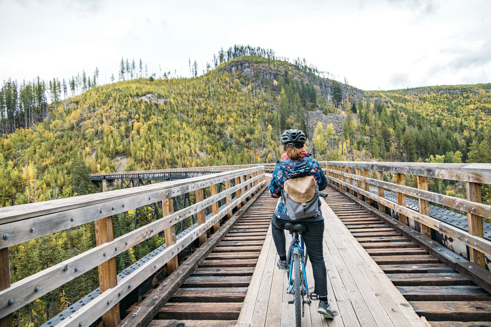 Cyclist crossing a wooden railway trestle