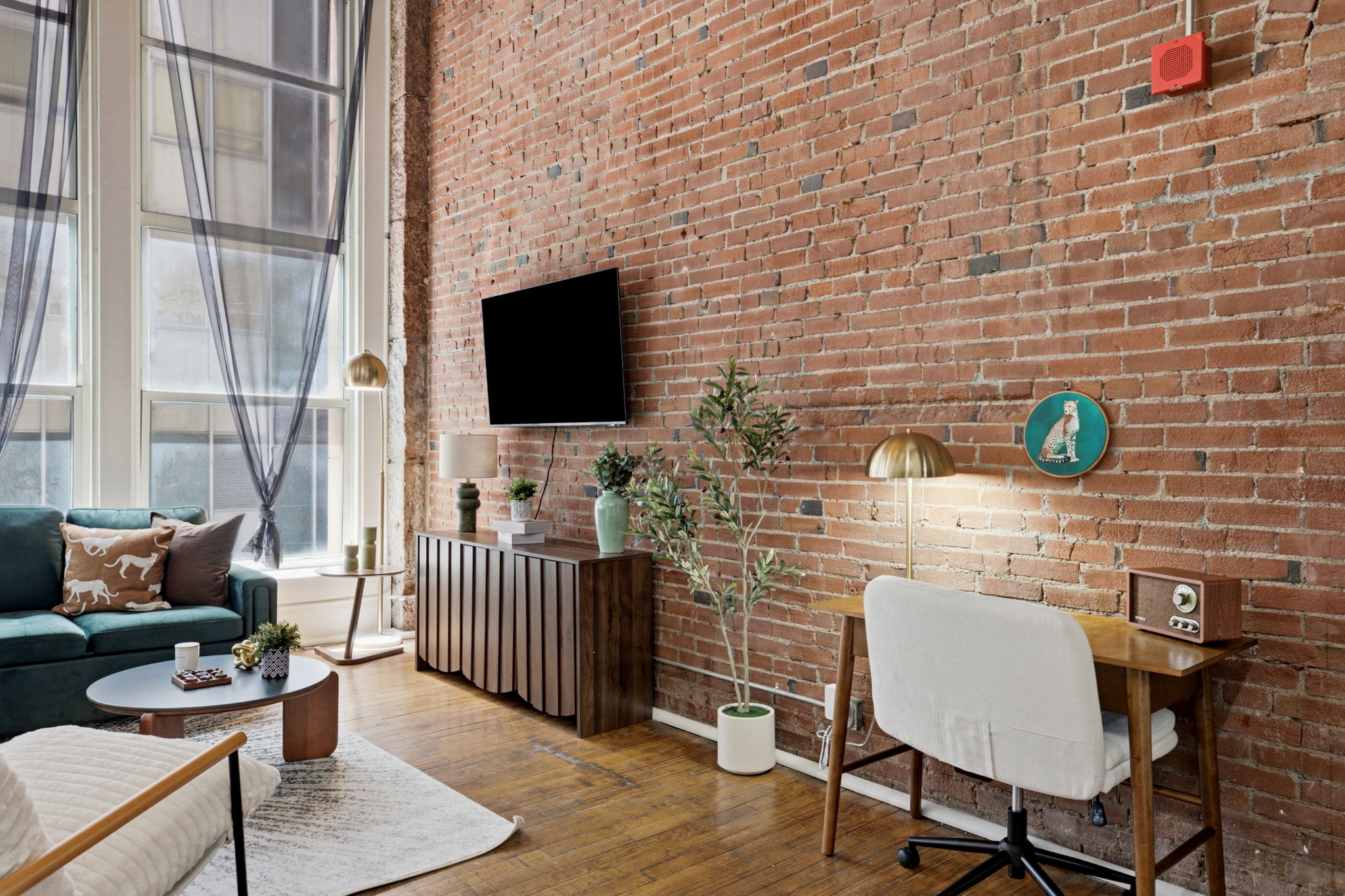 Exposed brick living and dining area at the St. Louis SixCord loft